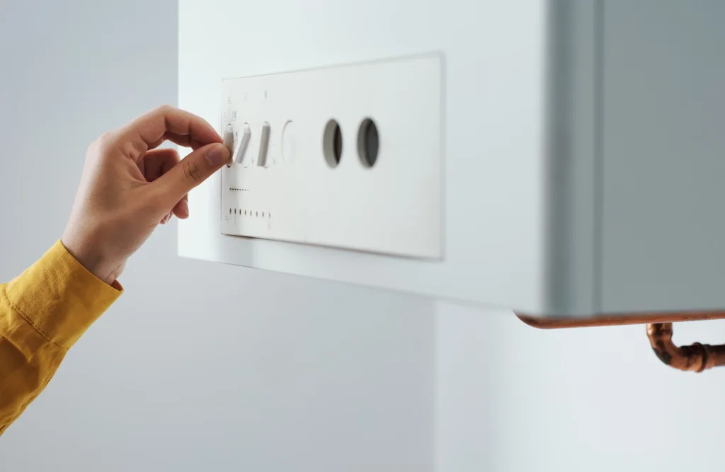 Woman checking settings on the boiler